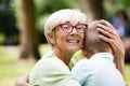 Loving senior woman embracing her grandchildren with a cheerful smile on her face Royalty Free Stock Photo