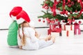 Loving siblings in front of the christmas tree Royalty Free Stock Photo