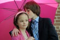 Loving  siblings under pink umbrella Royalty Free Stock Photo