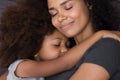 Loving single black mother hugs cute daughter feel tenderness connection Royalty Free Stock Photo