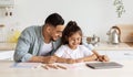 Loving single father and daughter painting together, kitchen interior Royalty Free Stock Photo