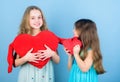 Loving sister. Sincere kids share tenderness and love. Girls hug red plush heart toy symbol love. Sisterhood concept Royalty Free Stock Photo