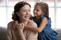 Loving small girl hug senior grandmother showing gratitude