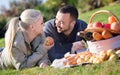 Loving smiling couple chatting as having picnic