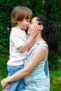 Loving son kissing his happy mother on the nose Royalty Free Stock Photo