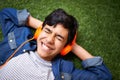 Loving this song. A young boy relaxing on the lawn and listening to music. Royalty Free Stock Photo