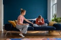 Loving supportive mother comforting upset crying teen daughter while sitting together on sofa Royalty Free Stock Photo