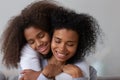 Loving teenage girl hug young mom from behind