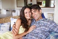 Loving the vacation. Portrait of an affectionate young couple relaxing on a couch on holiday. Royalty Free Stock Photo