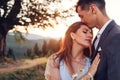 Loving wedding couple hugging in mountains at sunset. Portrait of bride and groom in summer Carpathians. Valentine`s day Royalty Free Stock Photo