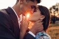 Loving wedding couple kissing in mountains at sunset. Portrait of bride and groom in summer Carpathians. Valentine`s day Royalty Free Stock Photo