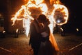 Loving wedding couple kissing and watching fire-show Royalty Free Stock Photo