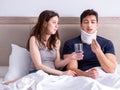 Loving wife taking care of injured husband in bed Royalty Free Stock Photo