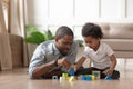 Loving black dad playing with son with building bricks Royalty Free Stock Photo