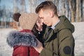 Loving young beautiful couple in the park on a bright sunny day. The guy and the girl are standing nose to nose and smiling Royalty Free Stock Photo