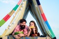 Loving young coupl near camp tent. Camping couple in love. Couples of lovers tourists eat watermelon relax on nature Royalty Free Stock Photo