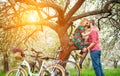 Loving young couple with bicycles in spring garden Royalty Free Stock Photo