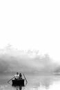 Loving young couple in boat at lake having romantic time. Black and white Royalty Free Stock Photo