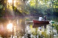 Loving young couple in boat at lake having romantic time. Royalty Free Stock Photo