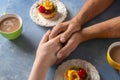 Loving young couple with coffee and desserts on color table Royalty Free Stock Photo