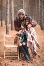 A loving couple in forest, a girl drinking tea, a guy hugging a girl from behind. Outdoors. Royalty Free Stock Photo