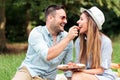 Loving young couple enjoying their time in a park, having a casual romantic picnic Royalty Free Stock Photo