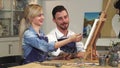 Loving young couple enjoying working on a painting at the Art Studio together