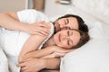 Loving young couple having cozy morning, cuddling together in their sleep on bed Royalty Free Stock Photo