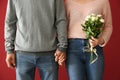 Loving young couple holding hands on color background Royalty Free Stock Photo