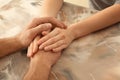 Loving young couple holding hands on color table, closeup Royalty Free Stock Photo