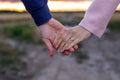 A loving young couple holding hands. Hands of a girl and a guy close-up. On a date boy and girl on the nature Royalty Free Stock Photo