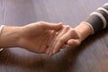 Loving young couple holding hands at table, closeup Royalty Free Stock Photo