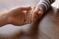 Loving young couple holding hands at table, closeup Royalty Free Stock Photo
