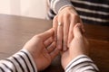 Loving young couple holding hands at table, closeup Royalty Free Stock Photo