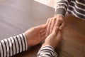 Loving young couple holding hands at table, closeup Royalty Free Stock Photo