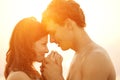 A loving young couple hugging and kissing on the beach at sunset Royalty Free Stock Photo