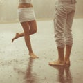 A loving young couple hugging and kissing under a rain. Lovers m Royalty Free Stock Photo