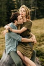 Loving young couple hugging together in nature on the background of mountains Royalty Free Stock Photo