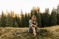 Loving young couple hugging together in nature on the background of mountains Royalty Free Stock Photo