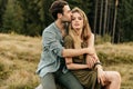 Loving young couple hugging together in nature on the background of mountains Royalty Free Stock Photo