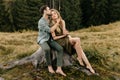 Loving young couple hugging together in nature on the background of mountains Royalty Free Stock Photo