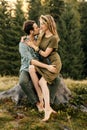 Loving young couple hugging together in nature on the background of mountains Royalty Free Stock Photo