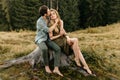 Loving young couple hugging together in nature on the background of mountains Royalty Free Stock Photo