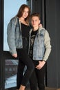 Young couple in jeans jackets together