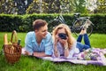 Loving young couple photo shooting and relaxing in a park. Royalty Free Stock Photo