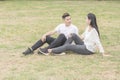 Loving young couple sitting down on grass Royalty Free Stock Photo