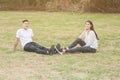 Loving young couple sitting down on grass Royalty Free Stock Photo