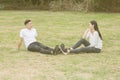 Loving young couple sitting down on grass Royalty Free Stock Photo