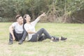 Loving young couple sitting down on grass Royalty Free Stock Photo