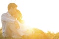 Loving young couple sitting on grass at park against clear sky Royalty Free Stock Photo